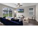 Comfortable living room featuring wood-look floors, a view of the backyard, and a contemporary design at 7745 Somersworth Dr, Kissimmee, FL 34747
