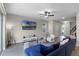Spacious living room featuring wood-look floors, staircase, and a seamless transition to the kitchen and dining area at 7745 Somersworth Dr, Kissimmee, FL 34747