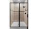Modern bathroom with a tiled shower featuring glass doors and sleek, dark hardware at 7745 Somersworth Dr, Kissimmee, FL 34747