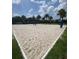 Sand volleyball court bordered by manicured grass, ideal for a beach-like experience at 7745 Somersworth Dr, Kissimmee, FL 34747