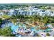 Overhead view of resort-style water park with lazy river, lush landscaping, and seating areas at 7745 Somersworth Dr, Kissimmee, FL 34747