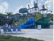 Community water park with slides, splash features, lounge chairs, and shaded areas at 7745 Somersworth Dr, Kissimmee, FL 34747