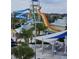 View of a colorful water park with slides, tables, chairs, and shaded areas at 7745 Somersworth Dr, Kissimmee, FL 34747
