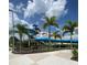 Community water park featuring tall slides, tropical landscaping, and paved walkways at 7745 Somersworth Dr, Kissimmee, FL 34747