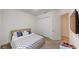 This carpeted bedroom features a double bed, closet, and door to the hallway at 8851 Fallen Oak Dr, Davenport, FL 33896
