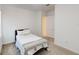 Carpeted bedroom with a queen bed, a decorative pillow, and paneled walls at 8851 Fallen Oak Dr, Davenport, FL 33896