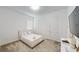 Cozy carpeted bedroom featuring a full bed, lots of natural light, and paneled walls at 8851 Fallen Oak Dr, Davenport, FL 33896