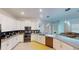 Modern kitchen features stainless steel appliances, sleek white cabinetry, and a stylish backsplash at 8851 Fallen Oak Dr, Davenport, FL 33896
