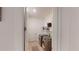 A convenient laundry room features a washer and dryer and a wall-mounted shelving unit at 8851 Fallen Oak Dr, Davenport, FL 33896