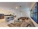 Spacious living room featuring tile flooring, a plush sofa, and a modern coffee table, open to the kitchen at 8851 Fallen Oak Dr, Davenport, FL 33896