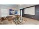 Comfortable living room boasting a projector screen, large windows, a plush sofa, and modern decor at 8851 Fallen Oak Dr, Davenport, FL 33896