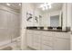 Bathroom featuring a double vanity, granite countertops, and a glass-enclosed shower at 8989 Rhodes St, Kissimmee, FL 34747