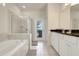 Bathroom featuring double vanity, soaking tub, and glass shower at 8989 Rhodes St, Kissimmee, FL 34747