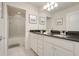 Bright bathroom featuring double vanity, granite countertops, and enclosed shower at 8989 Rhodes St, Kissimmee, FL 34747