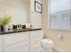 Clean bathroom with white cabinets, dark granite countertop, and window blinds at 8989 Rhodes St, Kissimmee, FL 34747