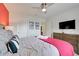 Bedroom featuring bright pink accents, modern furniture, and ample natural light at 8989 Rhodes St, Kissimmee, FL 34747