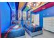 Fun room with Marvel design, twin beds and decorative lighting at 8989 Rhodes St, Kissimmee, FL 34747
