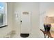 Bright foyer featuring a white door, tile floors, and natural light from the nearby window at 8989 Rhodes St, Kissimmee, FL 34747