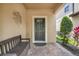 Inviting front porch with a bench and decorative accents, leading to a stylish front door at 8989 Rhodes St, Kissimmee, FL 34747
