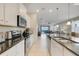 Bright, modern kitchen with stainless steel appliances, granite countertops, and an open view to the living area and pool at 8989 Rhodes St, Kissimmee, FL 34747