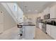 Modern kitchen featuring white cabinets, stainless steel appliances, and a large island with bar seating at 8989 Rhodes St, Kissimmee, FL 34747