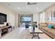 Relaxing living room with backyard views, plush seating, neutral tones, and lots of natural light at 8989 Rhodes St, Kissimmee, FL 34747