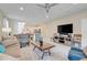 Comfortable living room with a ceiling fan, neutral colors, a modern rug, and plenty of natural light at 8989 Rhodes St, Kissimmee, FL 34747