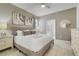 Comfortable main bedroom with soft tones, neutral colors, and an en-suite bathroom at 8989 Rhodes St, Kissimmee, FL 34747