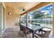 Covered patio features outdoor dining space with pool view and ceiling fan at 8989 Rhodes St, Kissimmee, FL 34747