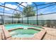 Relaxing backyard swimming pool with built-in spa and screened enclosure at 8989 Rhodes St, Kissimmee, FL 34747