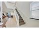 Elegant staircase with white railings, views into the dining area, and lots of natural light at 8989 Rhodes St, Kissimmee, FL 34747