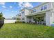 Large backyard with an outdoor living area that offers comfortable seating and dining with covered patio at 14189 Larkspur Lake Dr, Winter Garden, FL 34787