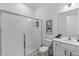 Full bathroom features a glass shower, toilet, and a single sink vanity with modern fixtures and decor at 14189 Larkspur Lake Dr, Winter Garden, FL 34787