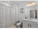 Full bathroom features a shower-tub combo with polka dot curtain, single sink vanity, and modern fixtures at 14189 Larkspur Lake Dr, Winter Garden, FL 34787