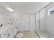 Clean and bright bathroom with a glass-enclosed shower, double vanity, and neutral tile flooring at 14189 Larkspur Lake Dr, Winter Garden, FL 34787