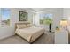 Inviting bedroom with neutral decor and abundant natural light from two large windows for a peaceful retreat at 14189 Larkspur Lake Dr, Winter Garden, FL 34787