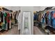 Large walk-in closet features ample storage space and a full-length mirror for added convenience at 14189 Larkspur Lake Dr, Winter Garden, FL 34787