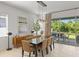 Elegant dining room with modern lighting, a large table, and easy access to the outdoor patio at 14189 Larkspur Lake Dr, Winter Garden, FL 34787