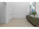 Bright foyer featuring tile floors, a console table, and an art piece enhancing the modern aesthetic at 14189 Larkspur Lake Dr, Winter Garden, FL 34787