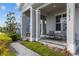 Inviting front porch featuring comfortable seating, offering a relaxing outdoor space with manicured landscaping at 14189 Larkspur Lake Dr, Winter Garden, FL 34787