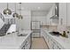 Modern kitchen featuring stainless steel appliances, a large island, and elegant pendant lighting at 14189 Larkspur Lake Dr, Winter Garden, FL 34787