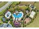 Aerial view of community pool and amenity center with playground and sand volleyball court at 1003 Nathan Ridge Rd, Clermont, FL 34715