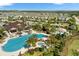 Aerial shot of community pool with splashpad, playground and lush landscaping at 1003 Nathan Ridge Rd, Clermont, FL 34715