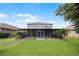 Beautifully landscaped backyard with a screened patio and lush green lawn at 1003 Nathan Ridge Rd, Clermont, FL 34715