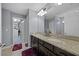 Bathroom featuring a double vanity, granite countertop, and walk-in closet at 1003 Nathan Ridge Rd, Clermont, FL 34715