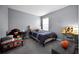 Cozy bedroom featuring a twin bed with a blue comforter, a desk, and playful decor at 1003 Nathan Ridge Rd, Clermont, FL 34715