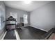 Exercise room with treadmill, rubber floor, natural light, and neutral paint at 1003 Nathan Ridge Rd, Clermont, FL 34715