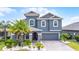 Beautiful two-story home with landscaped yard, blue exterior, and brick driveway at 1003 Nathan Ridge Rd, Clermont, FL 34715