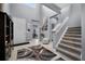 Bright foyer with high ceilings, tile flooring, staircase, and decorative rug at 1003 Nathan Ridge Rd, Clermont, FL 34715