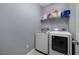 Laundry room with front load washer and dryer plus shelving at 1003 Nathan Ridge Rd, Clermont, FL 34715